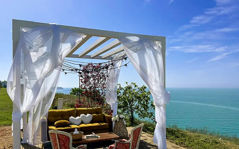Outdoor seating area with a canopy and ocean view